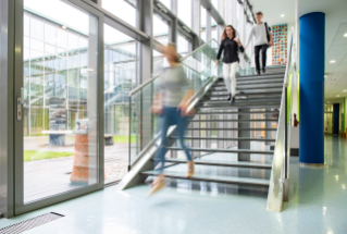 Staircase in an Open-Air Academic Building With Blurred People Walking Downstairs