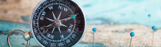 Compass with a map and pins