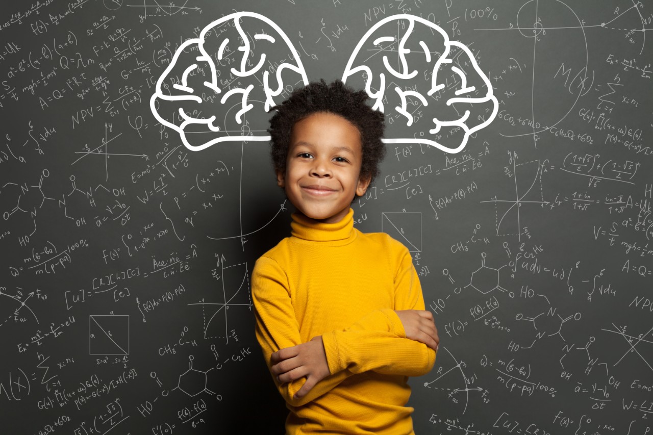 Smiling black child with big brain and science formulas on black, education and brainstorming concept