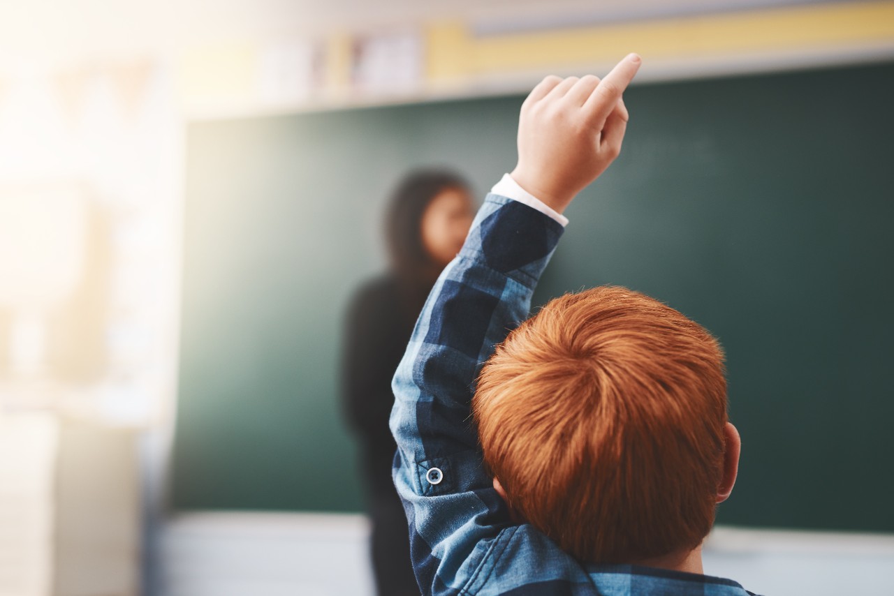 Cropped shot of elementary school children raising their hands to ask questions in the class