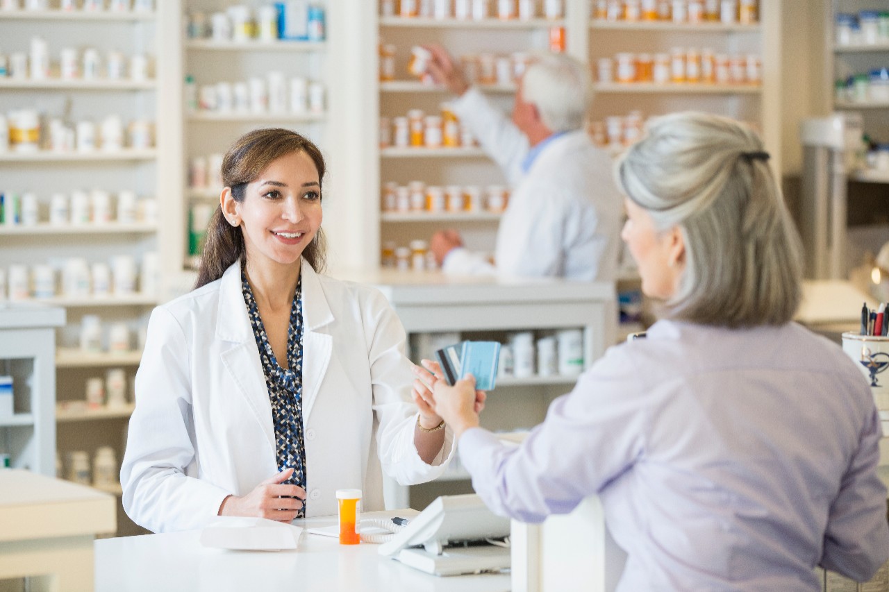 Pharmacist talking to customer