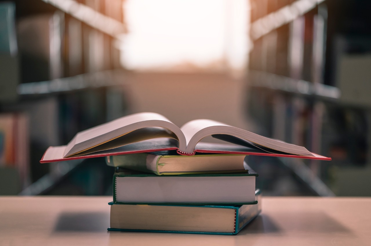 book, library, educator, lifestyle, knowledge, education concept. Opened book with stack of books on the desk wood in the libraryroom. Education illustration background concept.