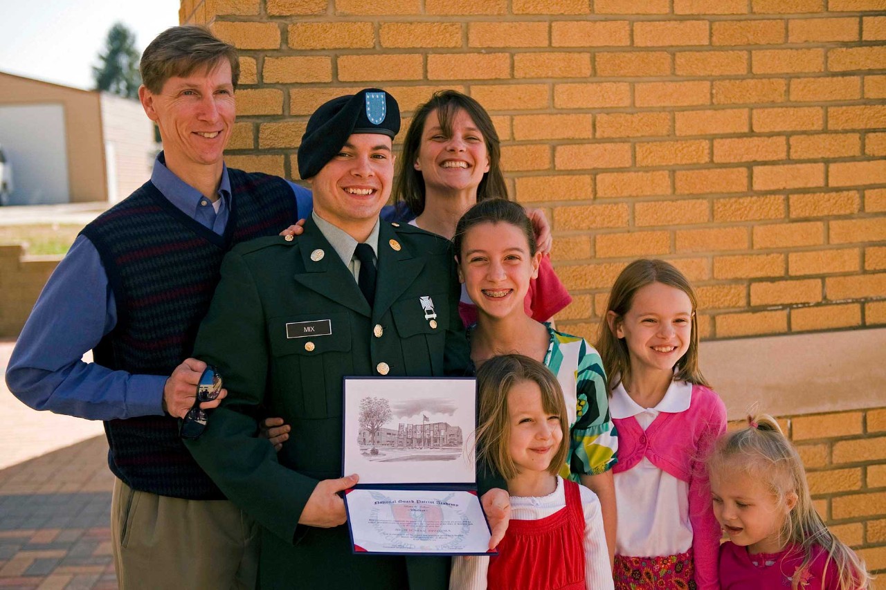 Pvt. 1st Class Scott Wayne proudly holds his newly earned high school diploma with smiling family members at the Patriot Academy’s first graduating class’ graduation ceremony at the Muscatatuck Urban Training Center in Butlerville, Ind., March 18. Scott didn’t have enough credits to graduate with his high school class. He decided to join the Patriot Academy to earn his diploma and serve his country. The Patriot Academy is the U.S. military’s first ever accredited high school. 